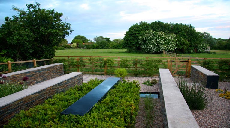 Limestone-capped walls lead the eye out into the pastoral landscape