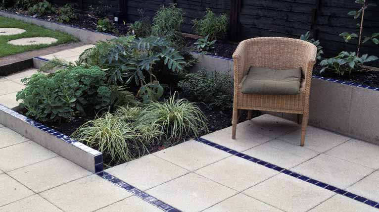Parallel lines of glazed tiles draw the eye down the garden