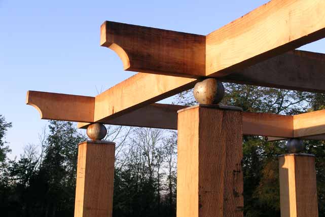 The pergola: oak joists sit on steel ball post caps