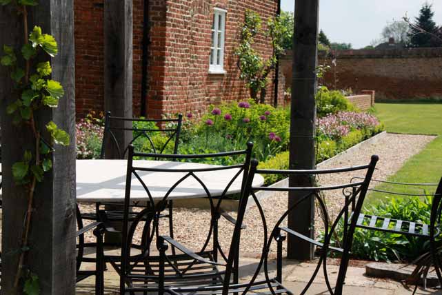 Looking under the pergola to the long border